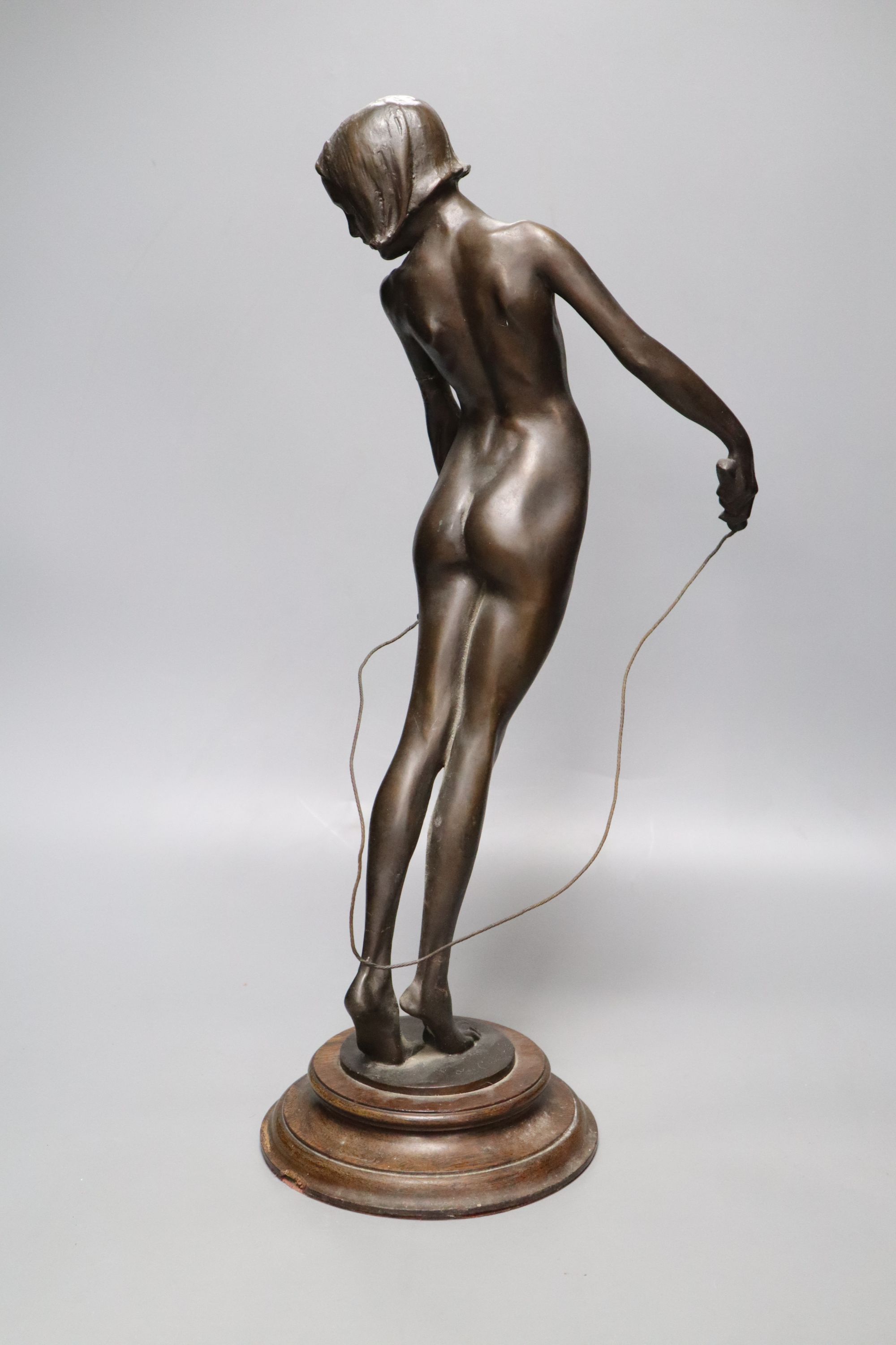 A spelter figure of girl with skipping rope, signed Alex Carnick?, height 49cm (a.f.)
